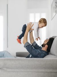 Father playing with his daughter at home