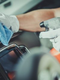 Worker Cleaning Car Dashboard. Taking Care of Vehicle Interior. Automotive Services.